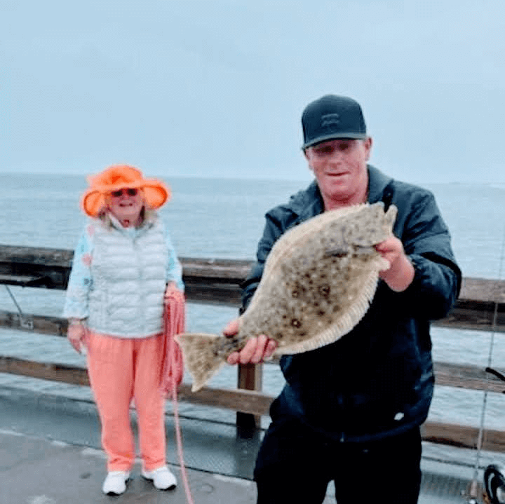 Snookie and Art Balboa Pier 9/2023, Art caught a halibut, Snookie netted it